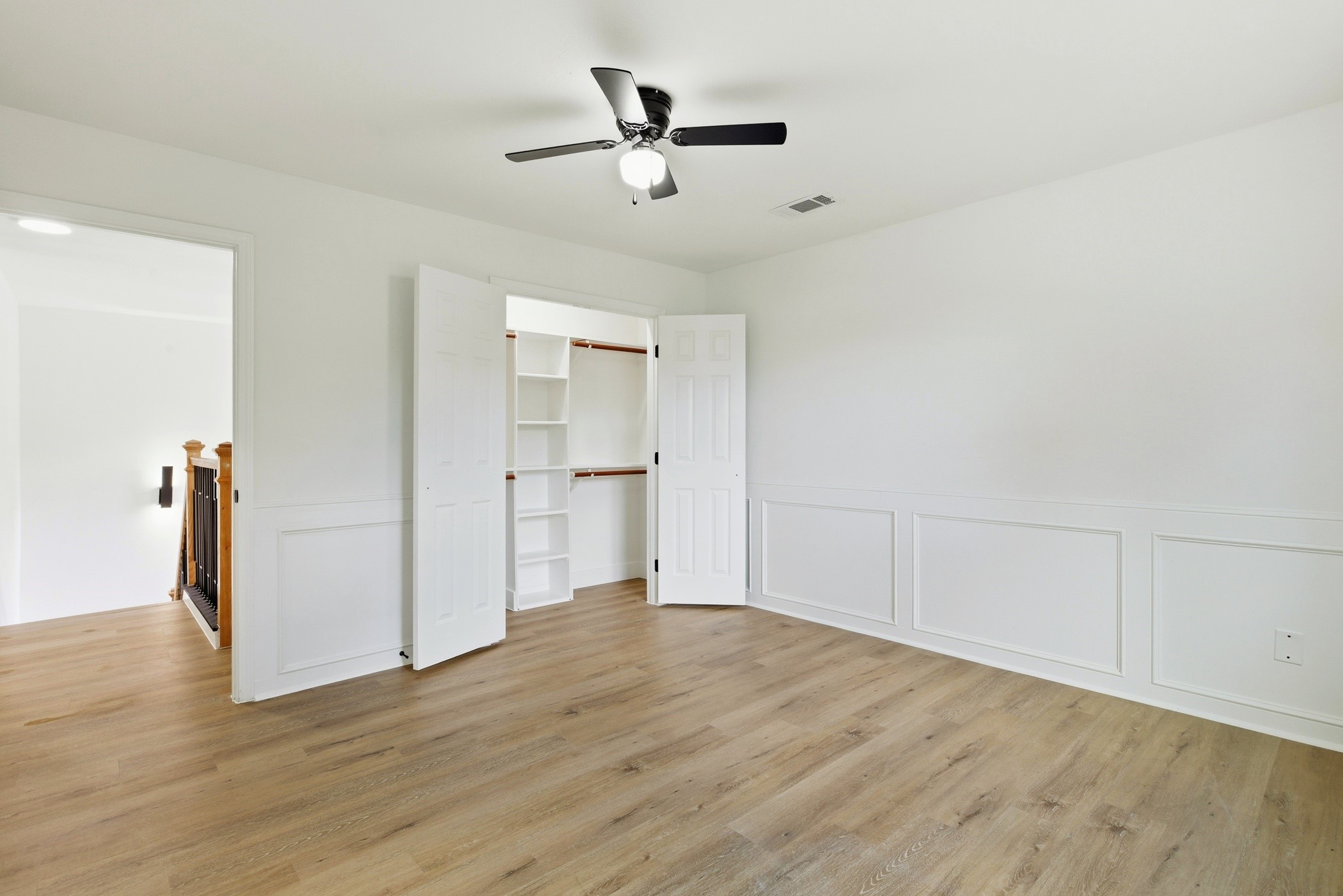 7338 San Ramon Drive Houston, TX 77083 - Photo 33 of 38 a view of empty room with wooden floor and ceiling fan