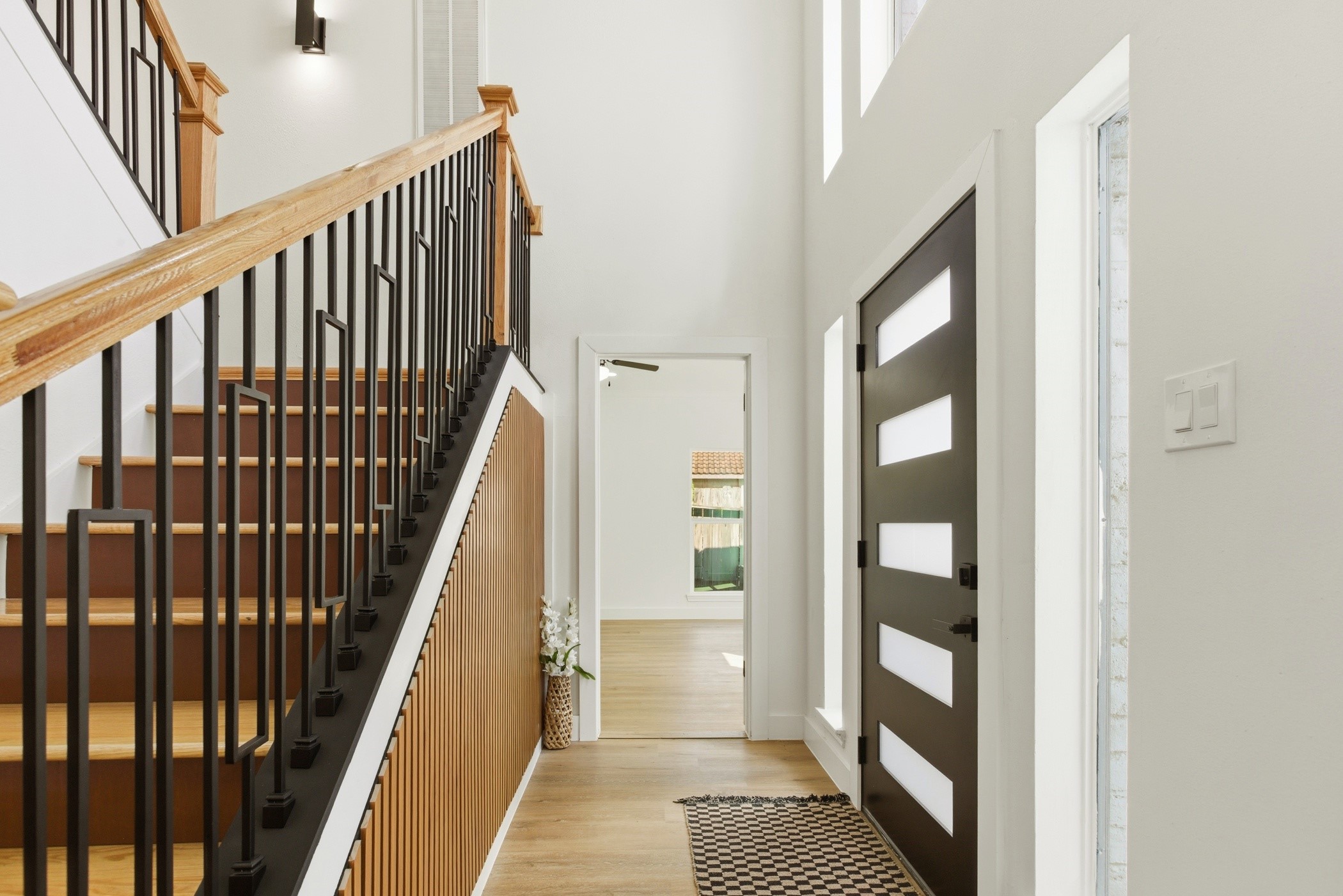 7338 San Ramon Drive Houston, TX 77083 - Photo 7 of 38 a view of a hallway with wooden floor and staircase