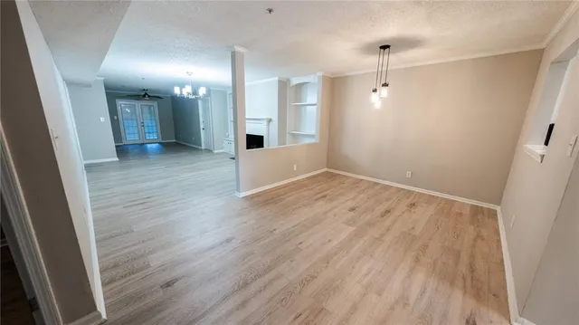 an empty room with wooden floor and a window