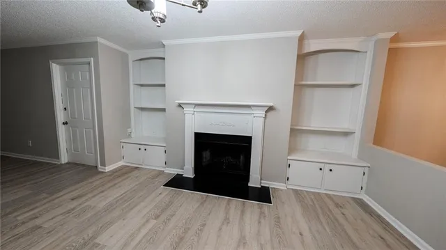 a view of a livingroom with a fireplace and a ceiling fan
