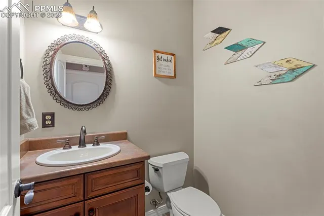 a bathroom with a toilet a sink and mirror