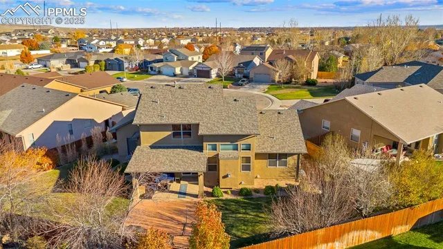 an aerial view of residential houses with outdoor space
