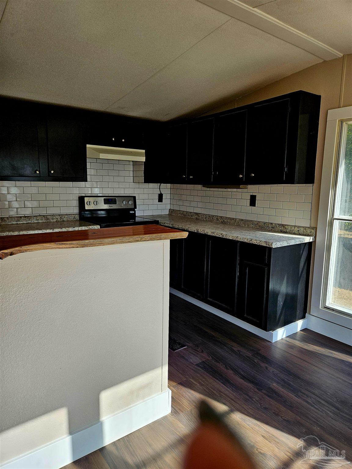 4240 Ewell Street Pace, FL 32571 - Photo 13 of 16 a kitchen with stainless steel appliances a stove a microwave and sink