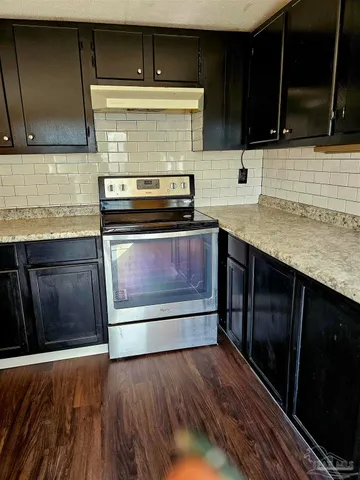 a view of kitchen island with sink