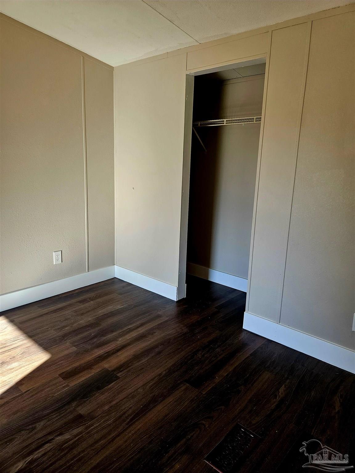4240 Ewell Street Pace, FL 32571 - Photo 5 of 16 a view of empty room with wooden floor and cabinet
