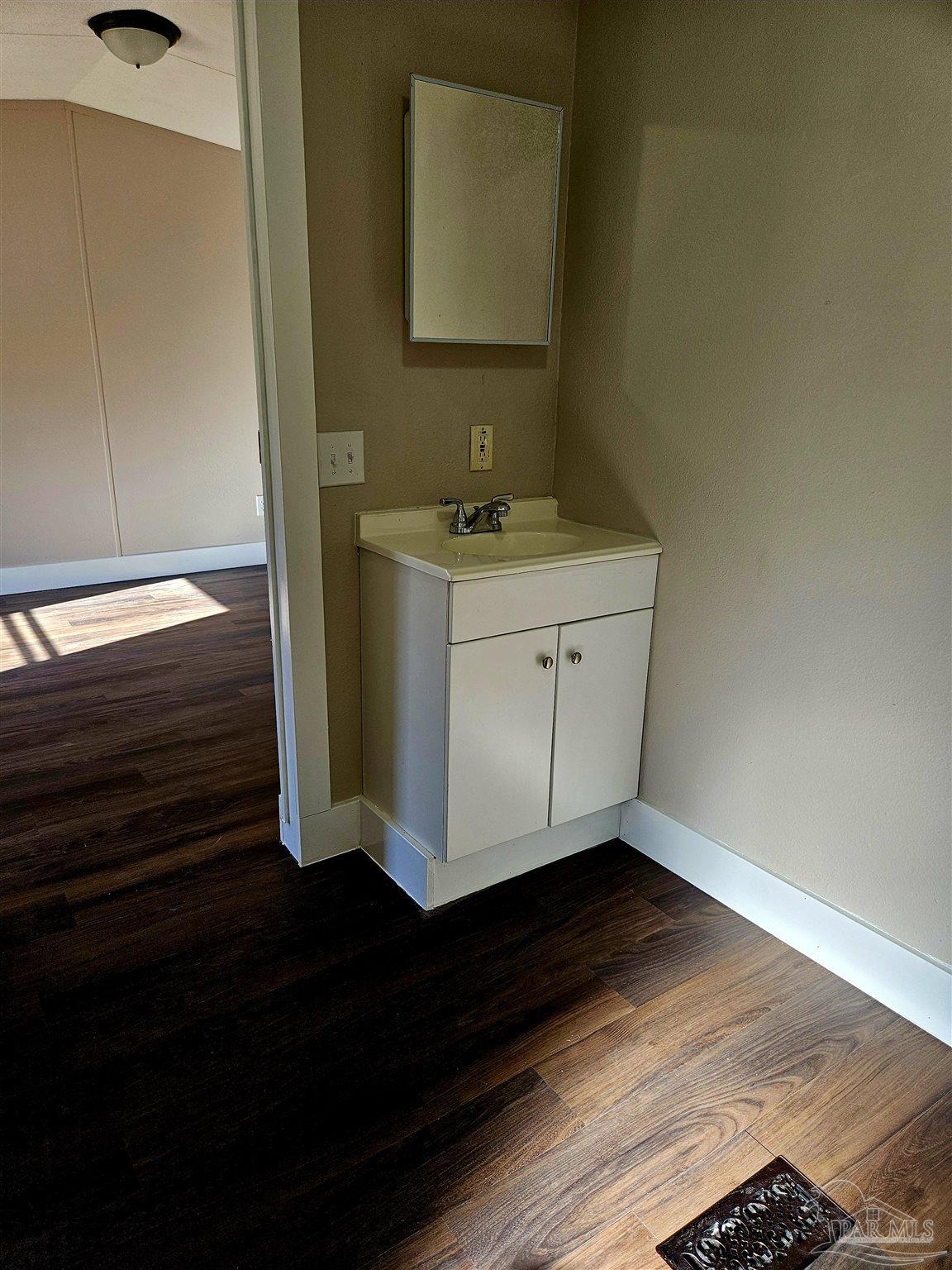 4240 Ewell Street Pace, FL 32571 - Photo 8 of 16 a bathroom with a sink and a mirror