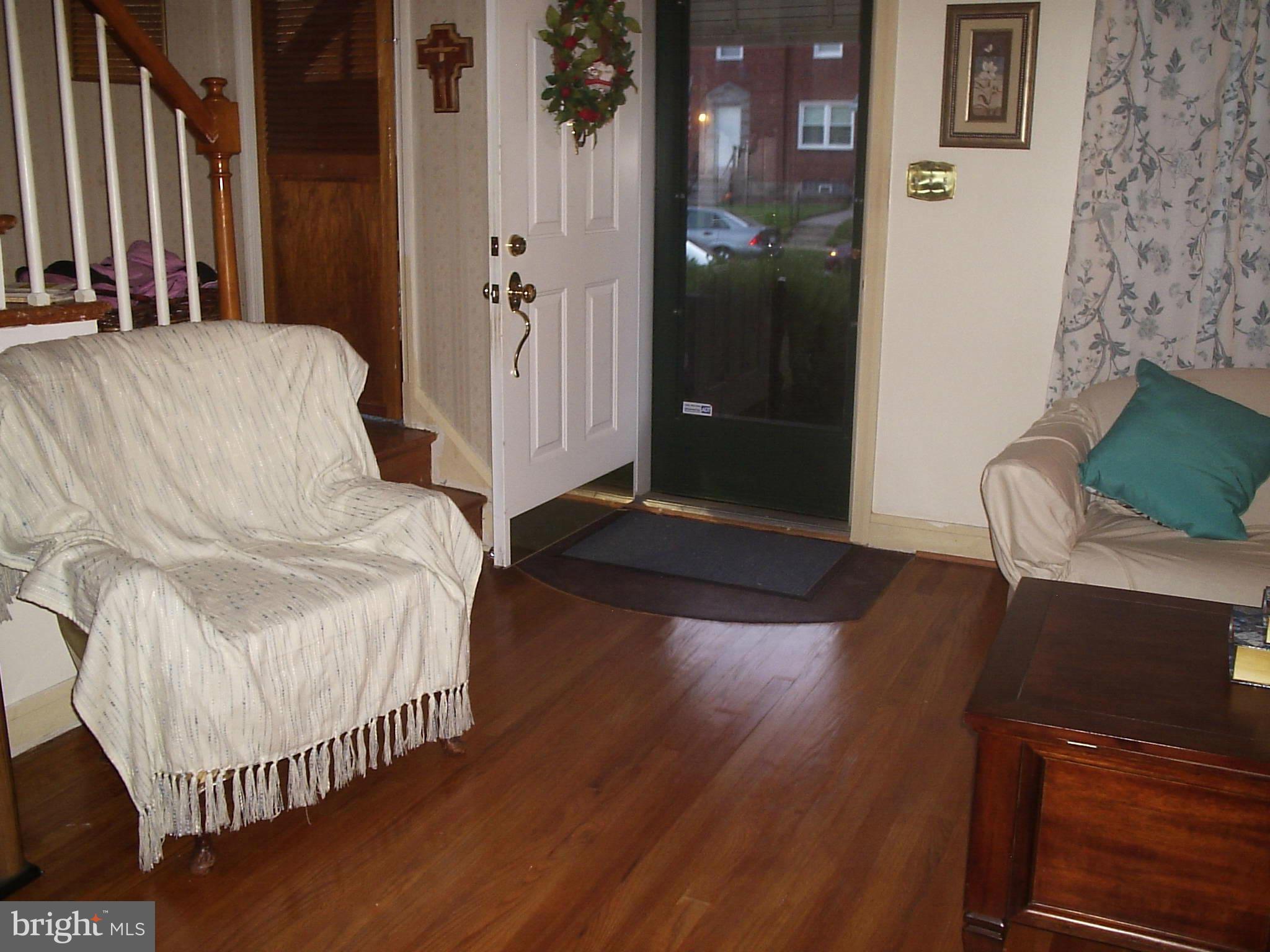 8617 Oak Road Baltimore, MD 21234 - Photo 2 of 16 a bedroom with a bed and wooden floor