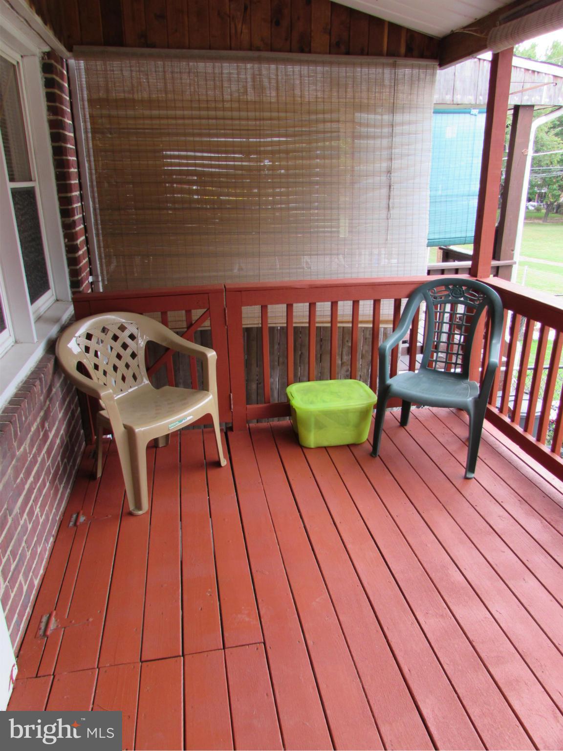8617 Oak Road Baltimore, MD 21234 - Photo 14 of 16 a balcony with wooden floor table and chairs