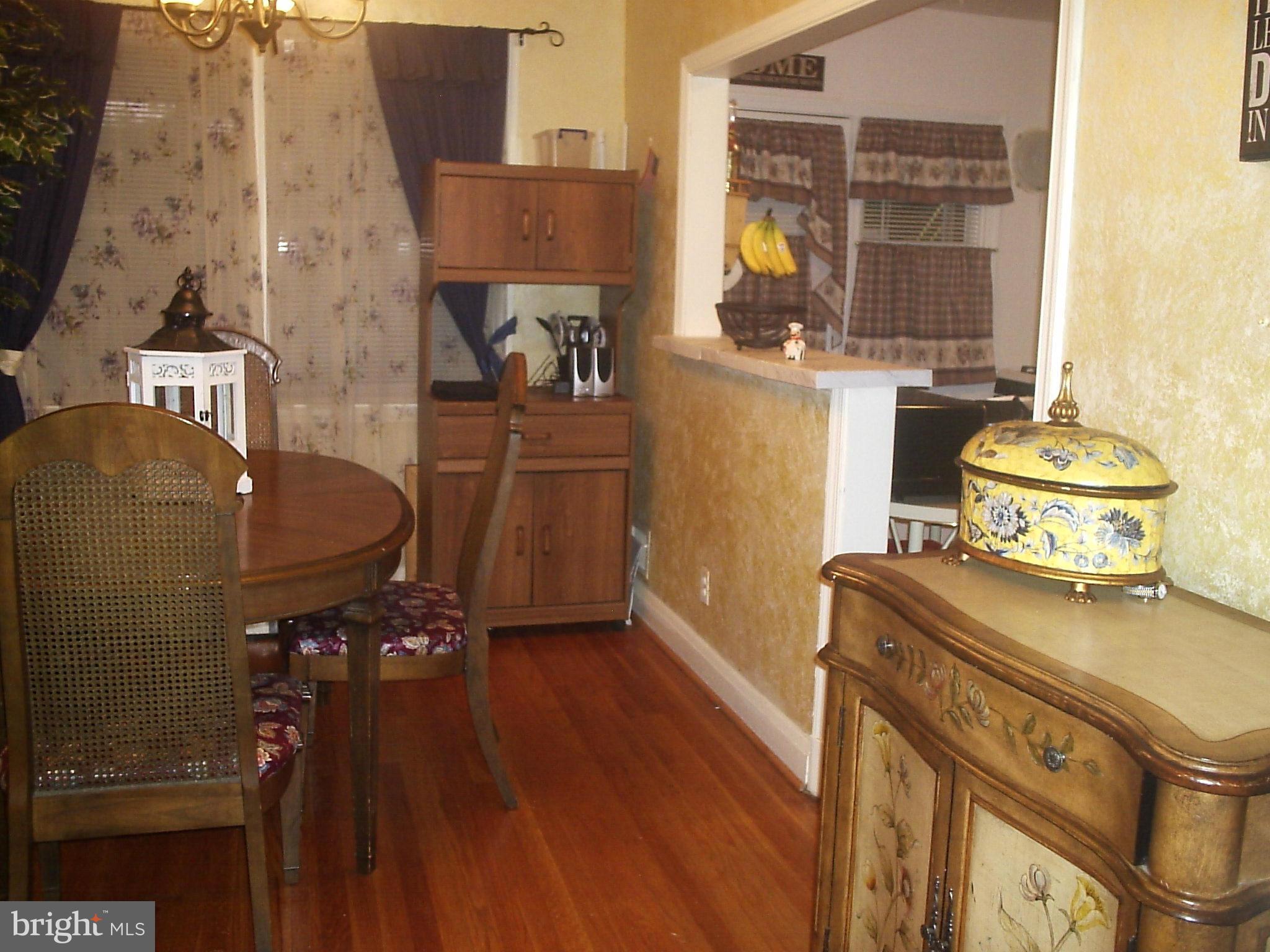 8617 Oak Road Baltimore, MD 21234 - Photo 6 of 16 a room with a stove and wooden cabinets