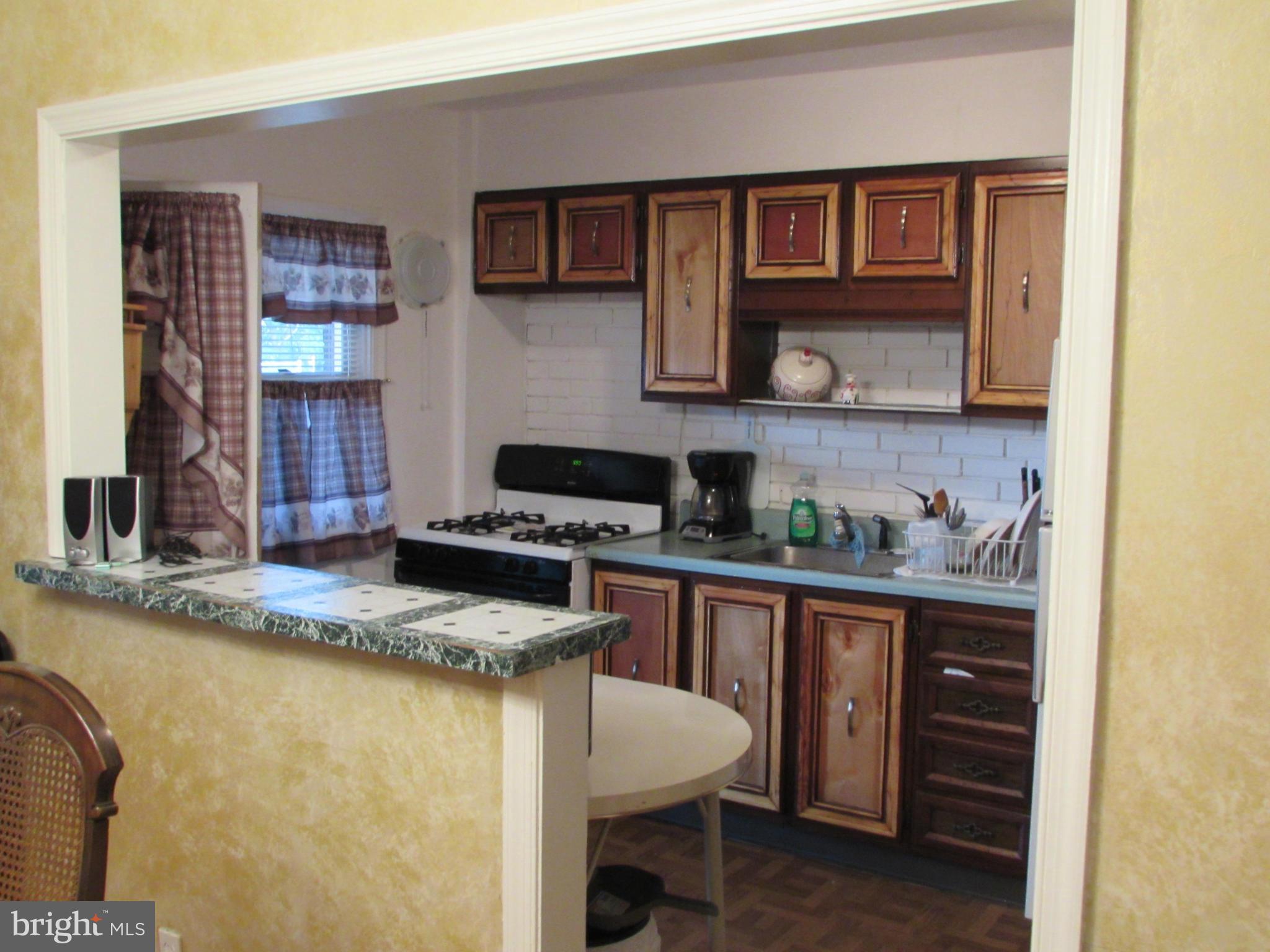 8617 Oak Road Baltimore, MD 21234 - Photo 9 of 16 a kitchen with granite countertop a sink and a stove