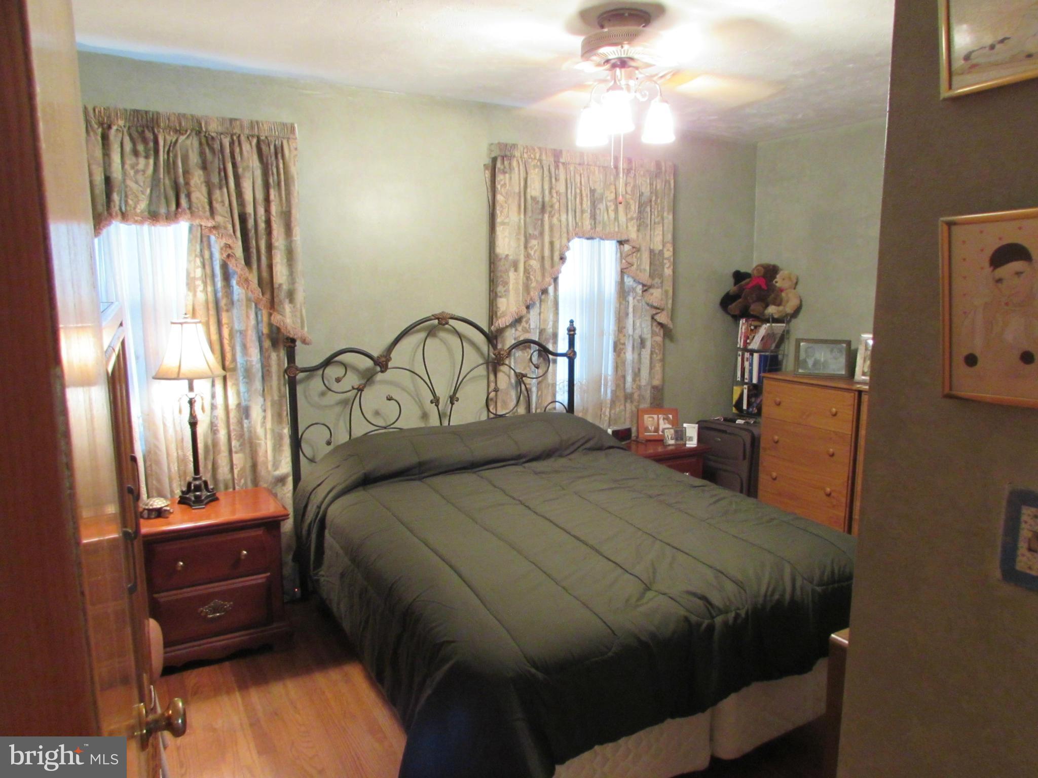 8617 Oak Road Baltimore, MD 21234 - Photo 10 of 16 a bedroom with a bed and a chandelier