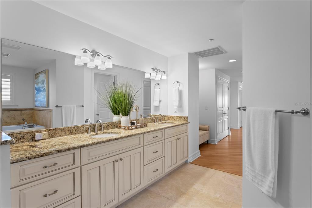 19730 Gulf Boulevard, Unit 400 Indian Rocks Beach, FL 33785 - Photo 47 of 90 a spacious bathroom with a granite countertop sink a mirror and a shower