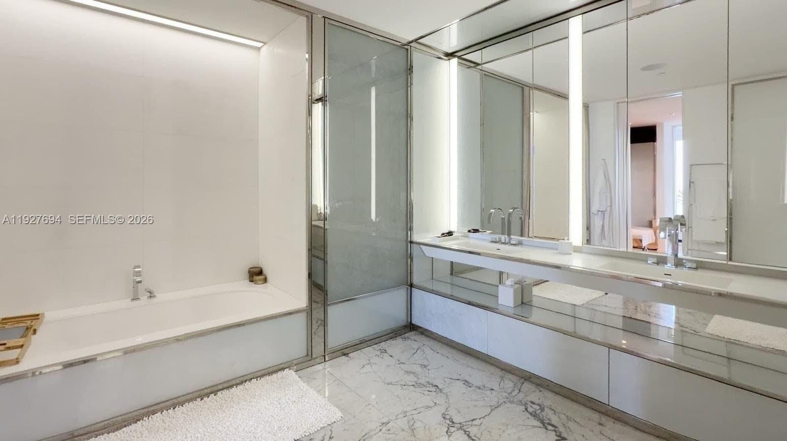 3315 Collins Avenue, Unit 10A Miami Beach, FL 33140 - Photo 31 of 48 a bathroom with a bathtub and a sink
