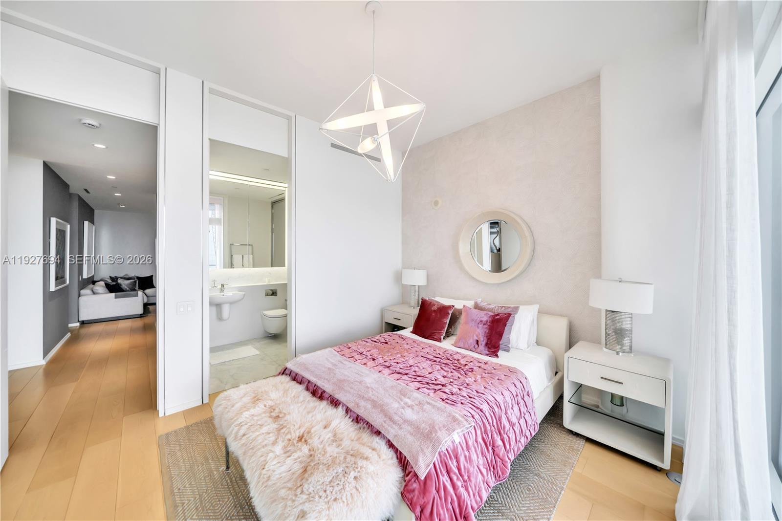 3315 Collins Avenue, Unit 10A Miami Beach, FL 33140 - Photo 37 of 48 a bedroom with a bed and a chandelier