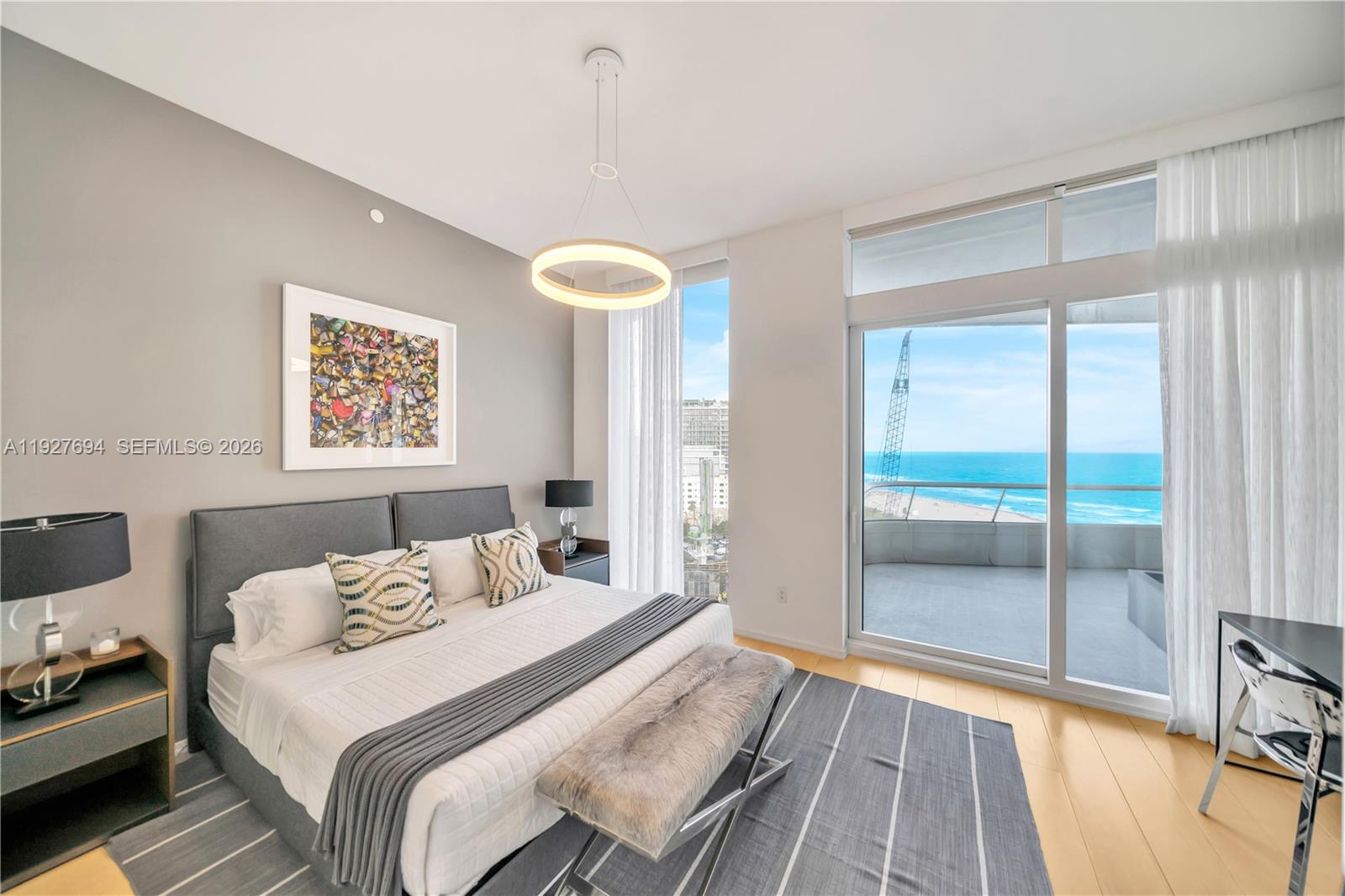 3315 Collins Avenue, Unit 10A Miami Beach, FL 33140 - Photo 40 of 48 a bedroom with a bed and wooden floor