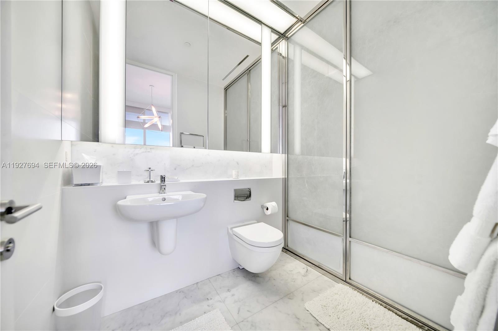 3315 Collins Avenue, Unit 10A Miami Beach, FL 33140 - Photo 44 of 48 a bathroom with a sink toilet and shower