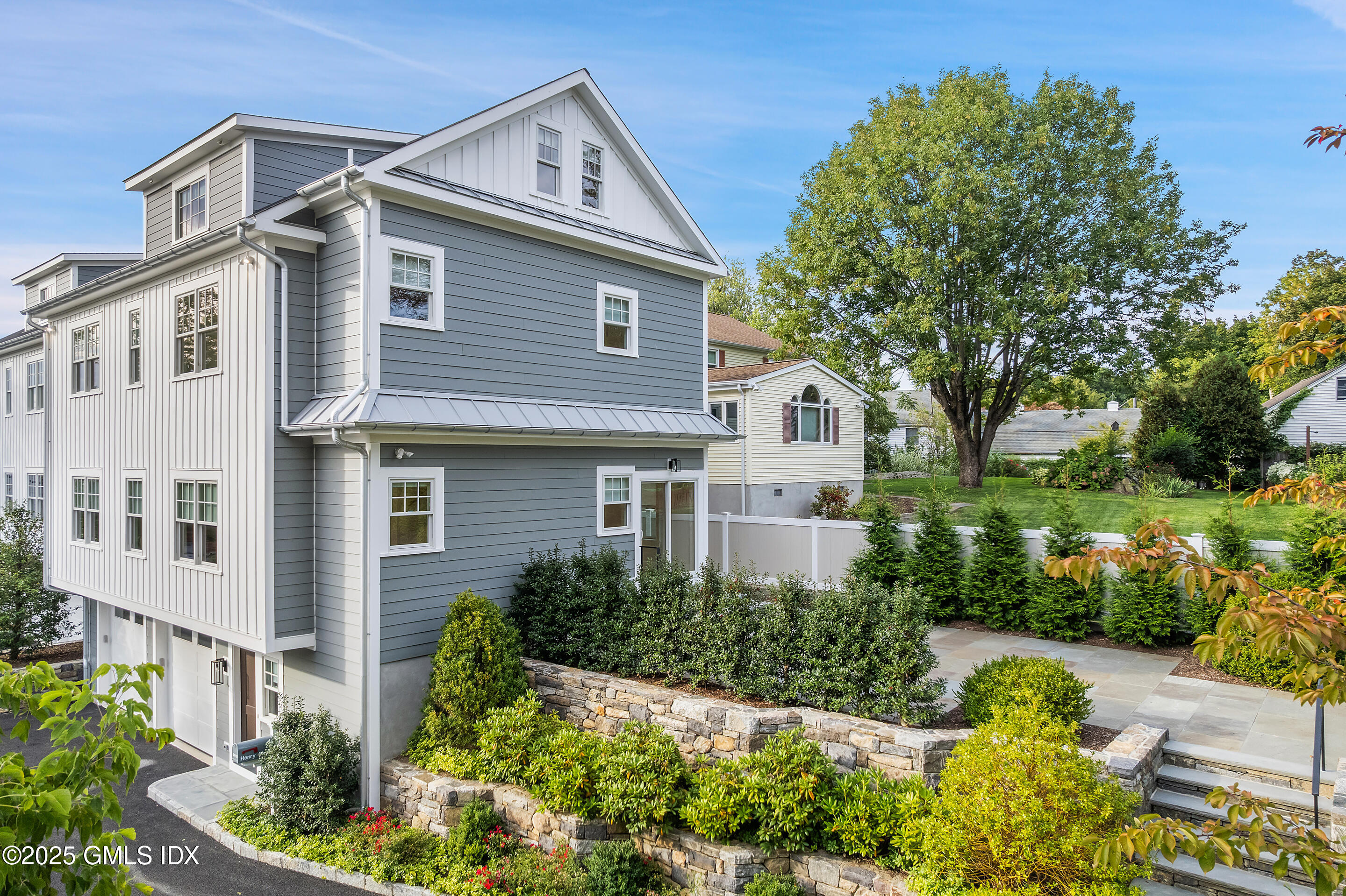 25 Henry Street, Unit B Greenwich, CT 06830 - Photo 5 of 8 a front view of a house with a yard