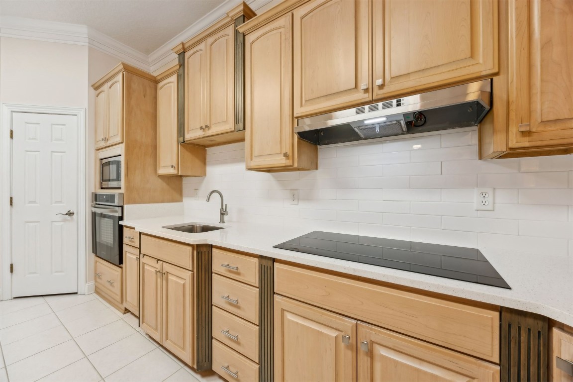 96075 High Pointe Drive Fernandina Beach, FL 32034 - Photo 14 of 42 a kitchen with stainless steel appliances granite countertop a sink and a white cabinets