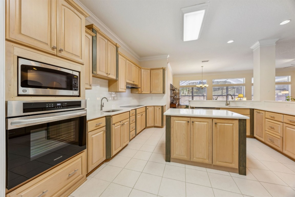96075 High Pointe Drive Fernandina Beach, FL 32034 - Photo 15 of 42 a kitchen with stainless steel appliances granite countertop a stove microwave and cabinets