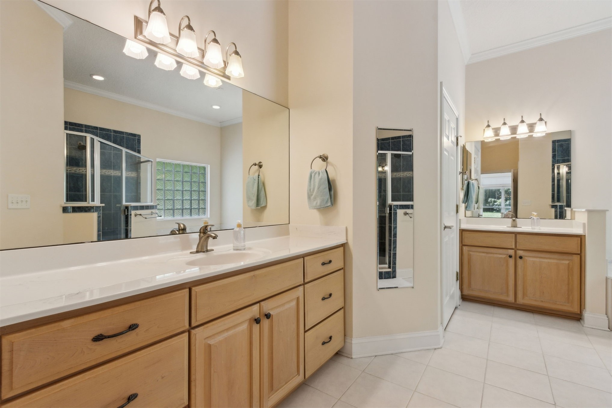 96075 High Pointe Drive Fernandina Beach, FL 32034 - Photo 20 of 42 a spacious bathroom with a granite countertop sink a large mirror and a shower