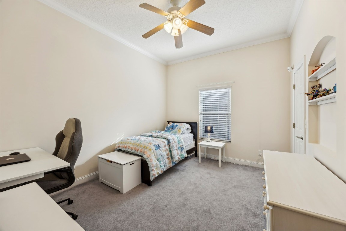 96075 High Pointe Drive Fernandina Beach, FL 32034 - Photo 22 of 42 a bedroom with a bed and a chandelier