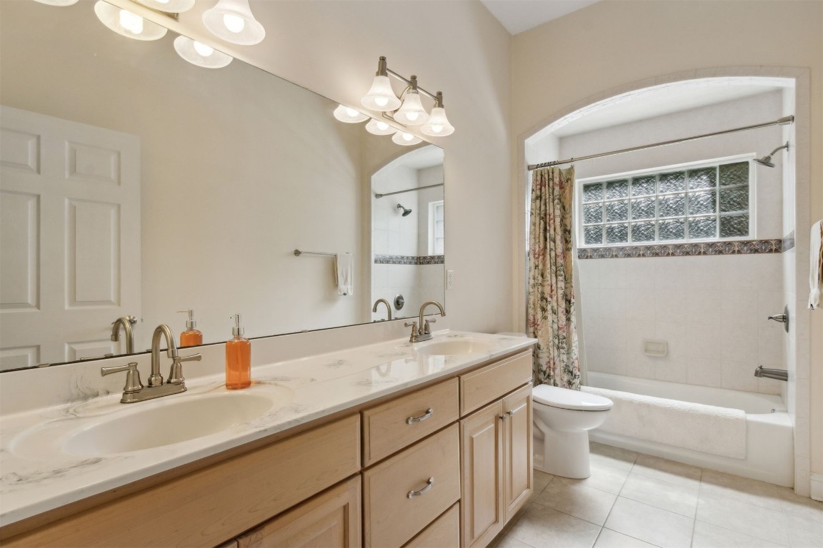 96075 High Pointe Drive Fernandina Beach, FL 32034 - Photo 23 of 42 a bathroom with a granite countertop sink a toilet a bathtub a mirror and vanity