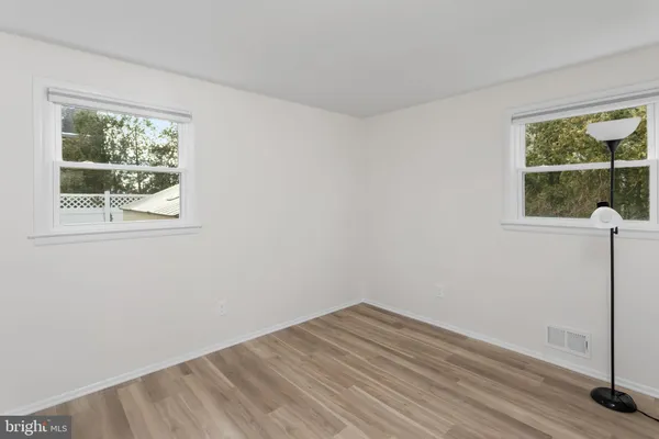 a view of room with window and hardwood floor
