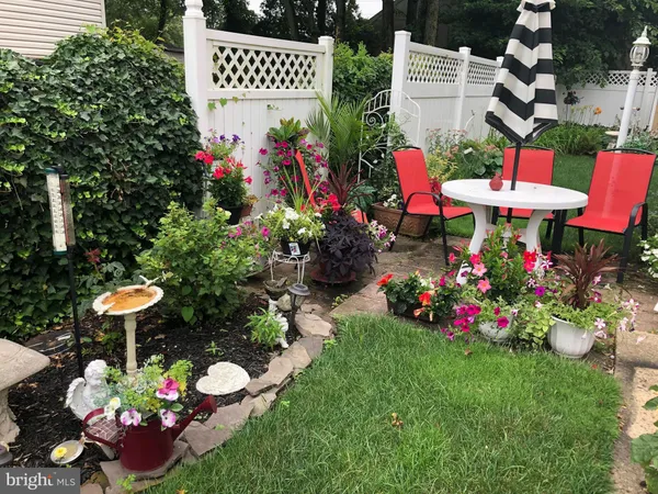 a front view of a house with a yard and potted plants