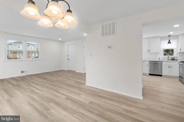 a view of a kitchen with a dishwasher cabinets and wooden floor