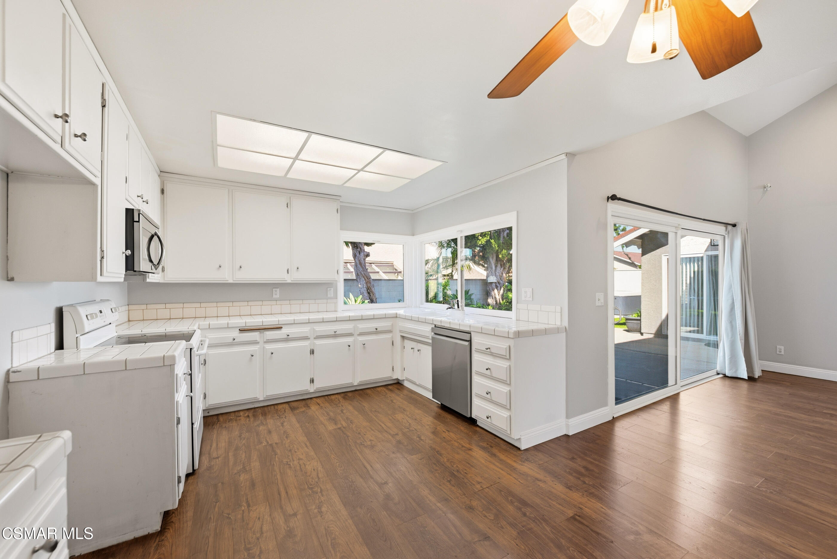 2249 St Clair Avenue Simi Valley, CA 93063 - Photo 22 of 60 a kitchen with granite countertop white cabinets and white appliances