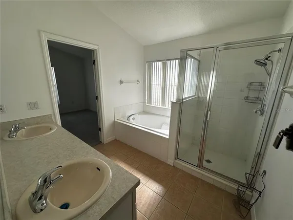 a bathroom with a tub sink and shower
