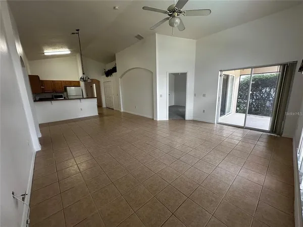 a view of a hallway with a couch and chandelier