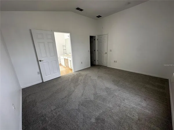 a view of an empty room and closet area