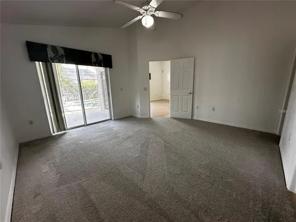 a view of a livingroom with a ceiling fan and window