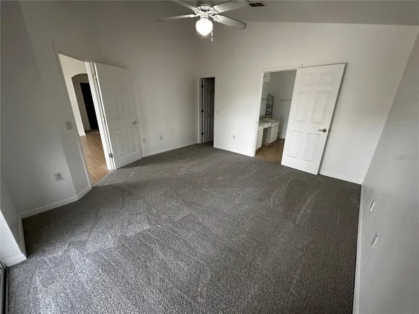 a view of a livingroom with a ceiling fan and window