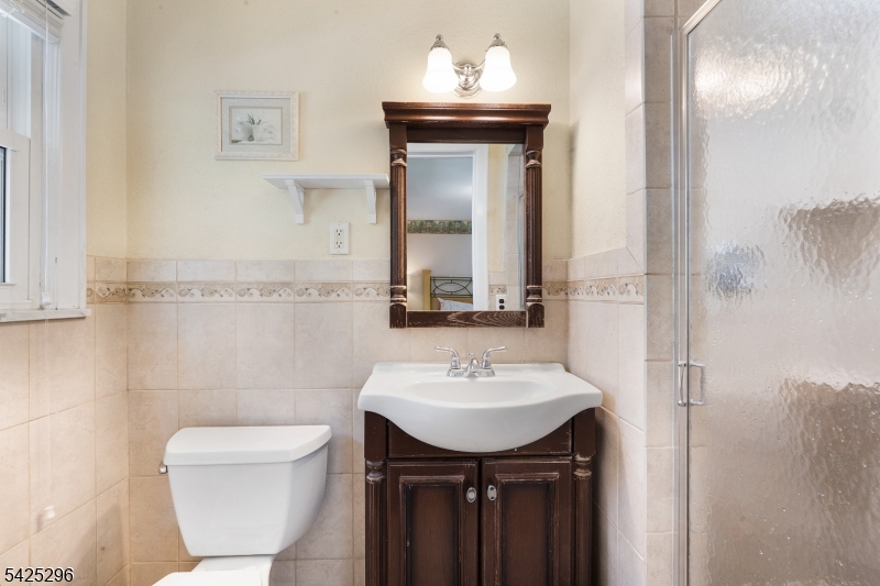 156 Wentz Avenue Springfield, NJ 07081 - Photo 14 of 27 a bathroom with a sink toilet and mirror