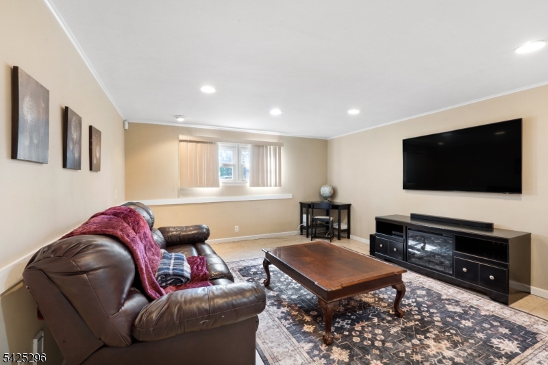 156 Wentz Avenue Springfield, NJ 07081 - Photo 18 of 27 a living room with furniture and a flat screen tv