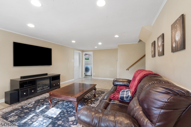 156 Wentz Avenue Springfield, NJ 07081 - Photo 19 of 27 a living room with furniture and a flat screen tv