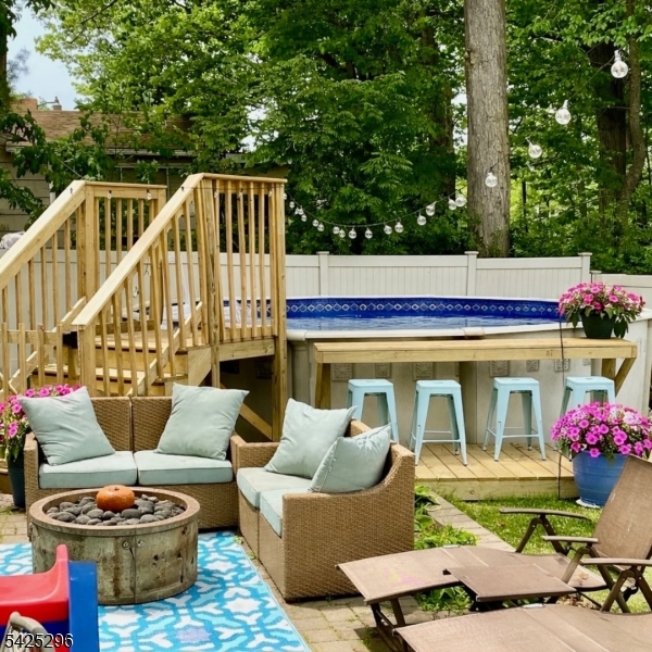 156 Wentz Avenue Springfield, NJ 07081 - Photo 23 of 27 a view of a chairs and tables in the back yard of a house