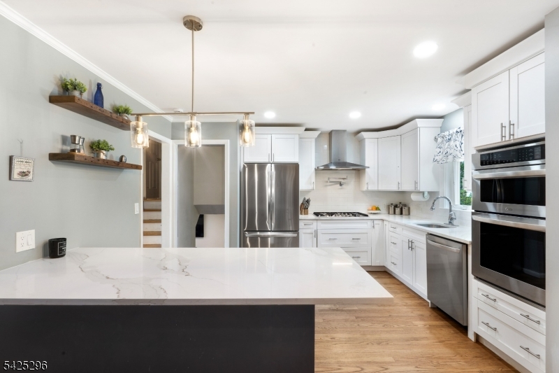 156 Wentz Avenue Springfield, NJ 07081 - Photo 7 of 27 a kitchen with kitchen island a sink stainless steel appliances and cabinets