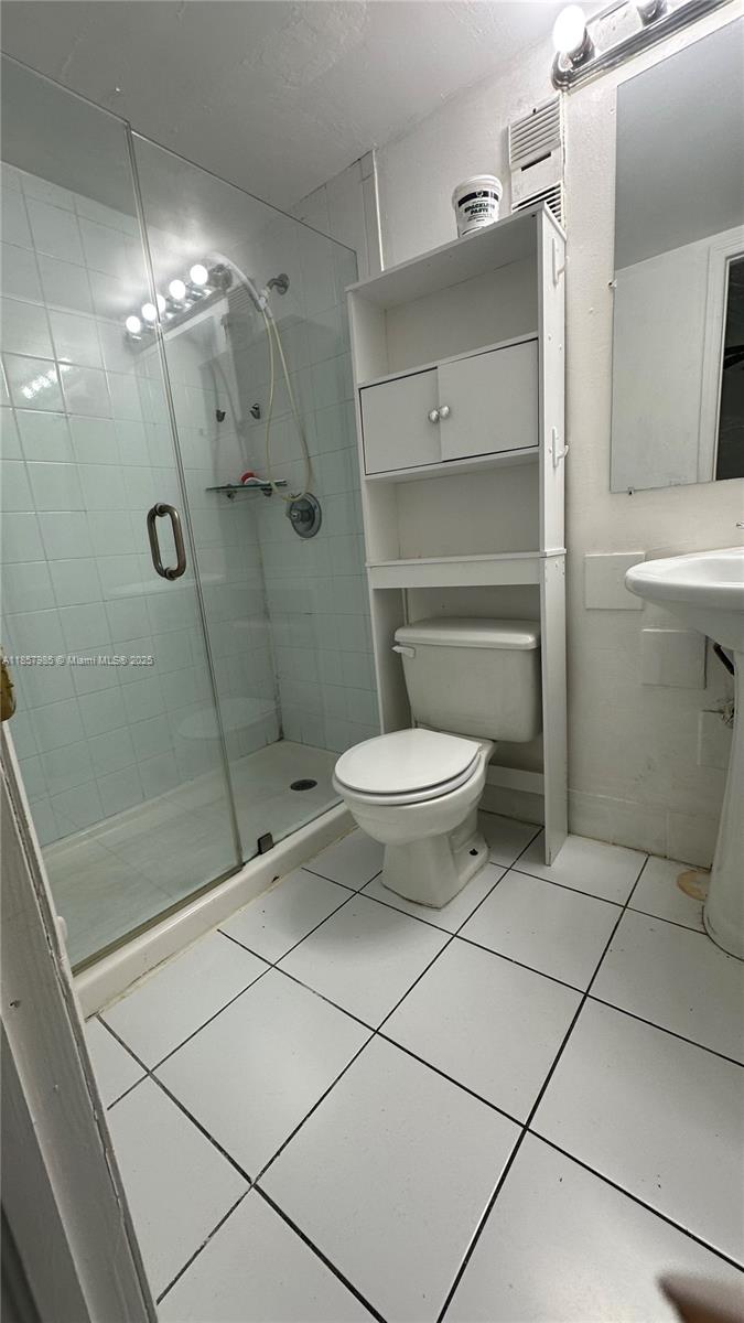 2138 Southwest 6th Street, Unit 102 Miami, FL 33135 - Photo 7 of 11 a bathroom with a toilet and a shower