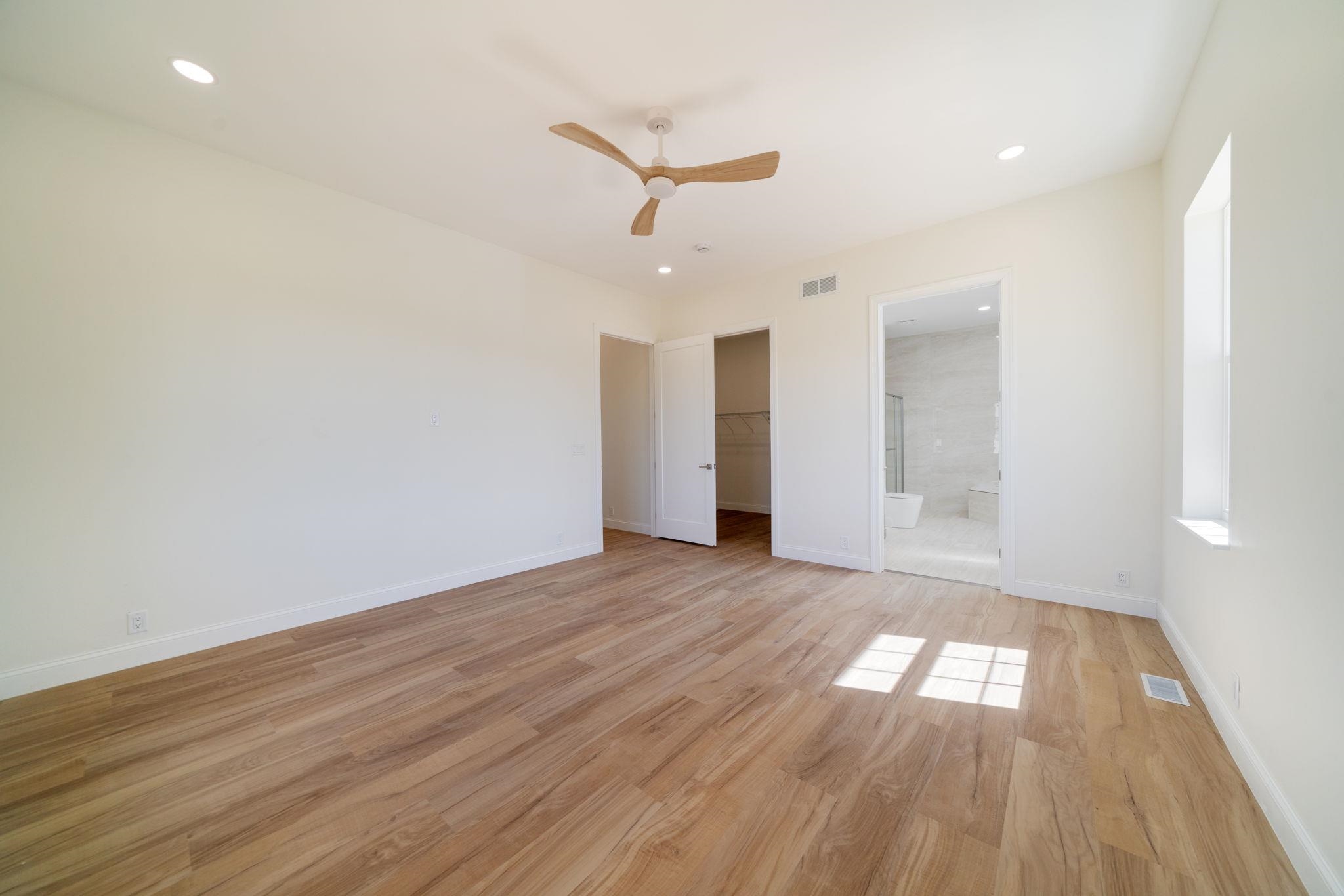 5145 Sycamore Ridge Road Belvidere, IL 61008 - Photo 23 of 57 an empty room with wooden floor ceiling fan and windows