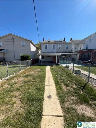 a view of a house with a backyard