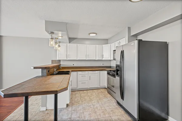 a kitchen with a refrigerator and a sink