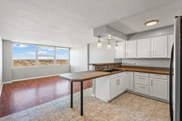a kitchen with a sink cabinets and window