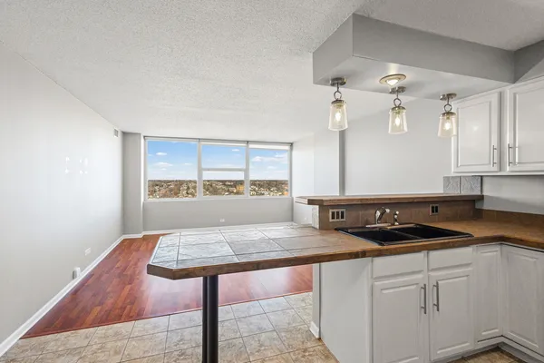 a kitchen with a sink cabinets and window