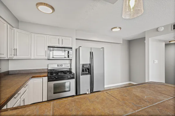 a kitchen with stainless steel appliances a refrigerator stove and sink
