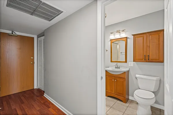 a bathroom with a sink a toilet a mirror and vanity