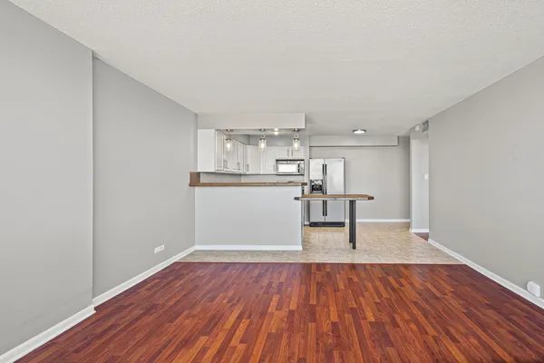 a view of kitchen with wooden floor and electronic appliances
