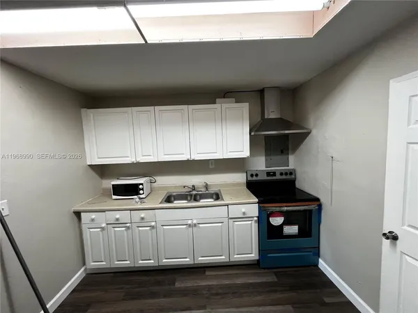 a kitchen with a stove and a refrigerator